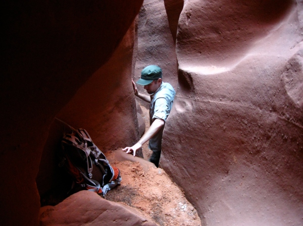 hiker climbs in spooky gulch slot canyon